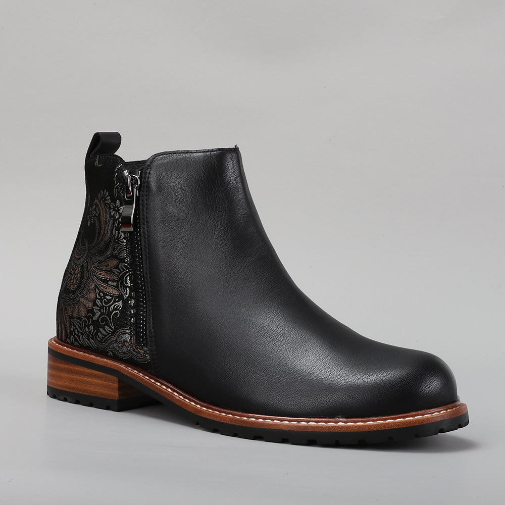 Le Sansa black printed boots featuring fig design, stylish footwear with bold graphic print and ankle-high cut.