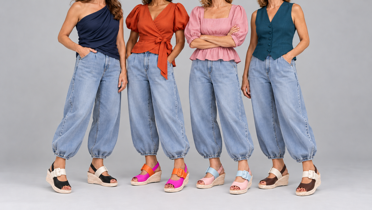 A model in an oversized brown shirt and wide-leg denim, against a concrete wall