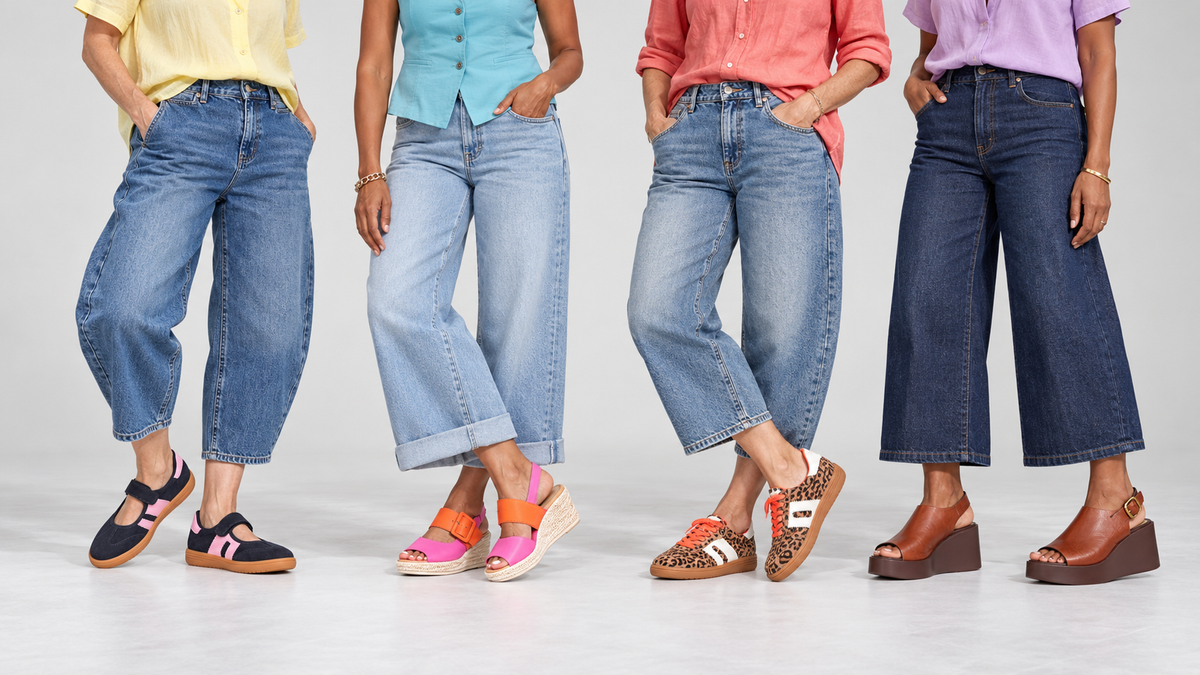 A model in an oversized brown shirt and wide-leg denim, against a concrete wall