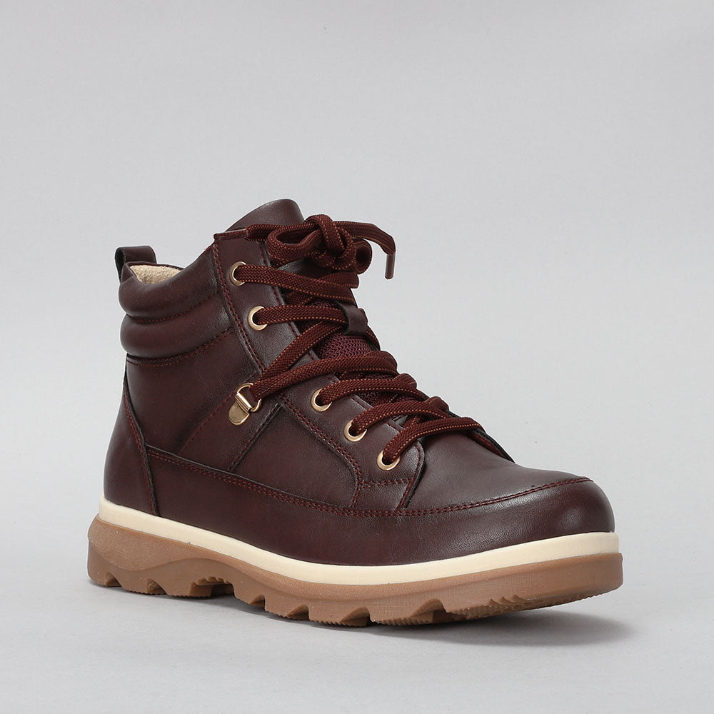 CC Resorts Gambian-inspired boots in earthy tones, featuring a stylish ankle-height design with decorative stitching and a sturdy sole.