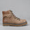 CC Resorts Grease Taupe boots featuring a sleek design and taupe-colored leather exterior.