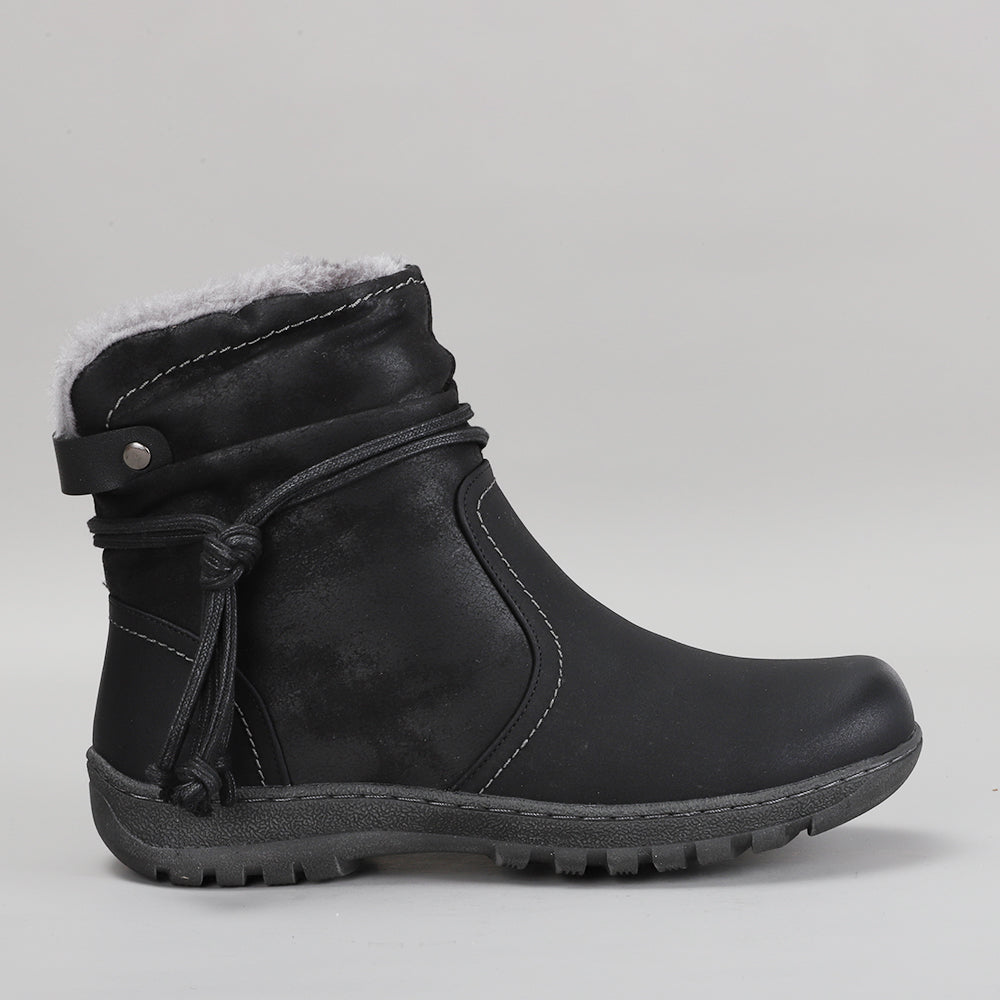 CC Resorts Gemma black boots shown from the side, featuring a sleek design with a rounded toe and low heel.