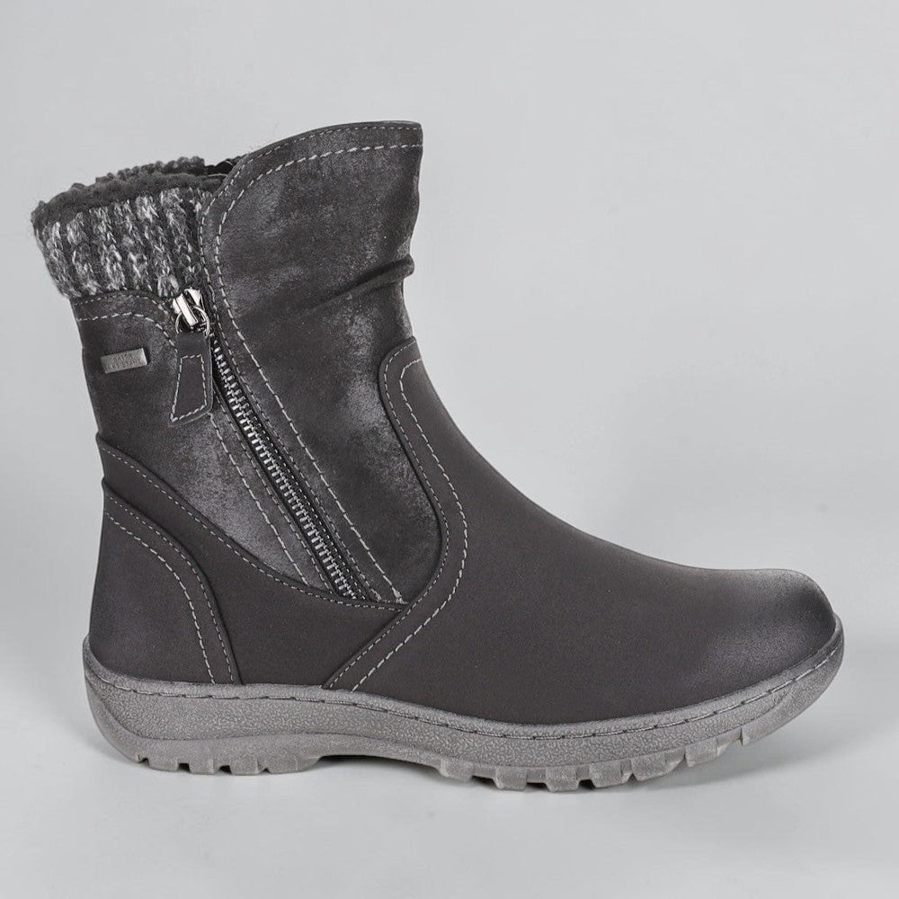 Black CC Resorts Glenda boots shown from the side, featuring sleek design and stylish ankle height.
