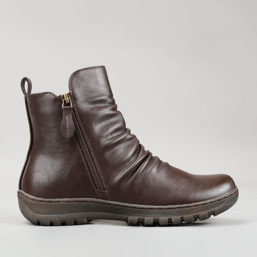 CC Resorts Greco Chocolate boots displayed from the side, featuring a stylish design and ankle-length style in rich chocolate color.