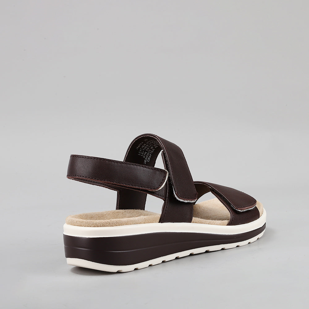 Naked Arches Hanza Chocolate sandals with brown leather straps and cushioned footbed, displayed on a neutral background.