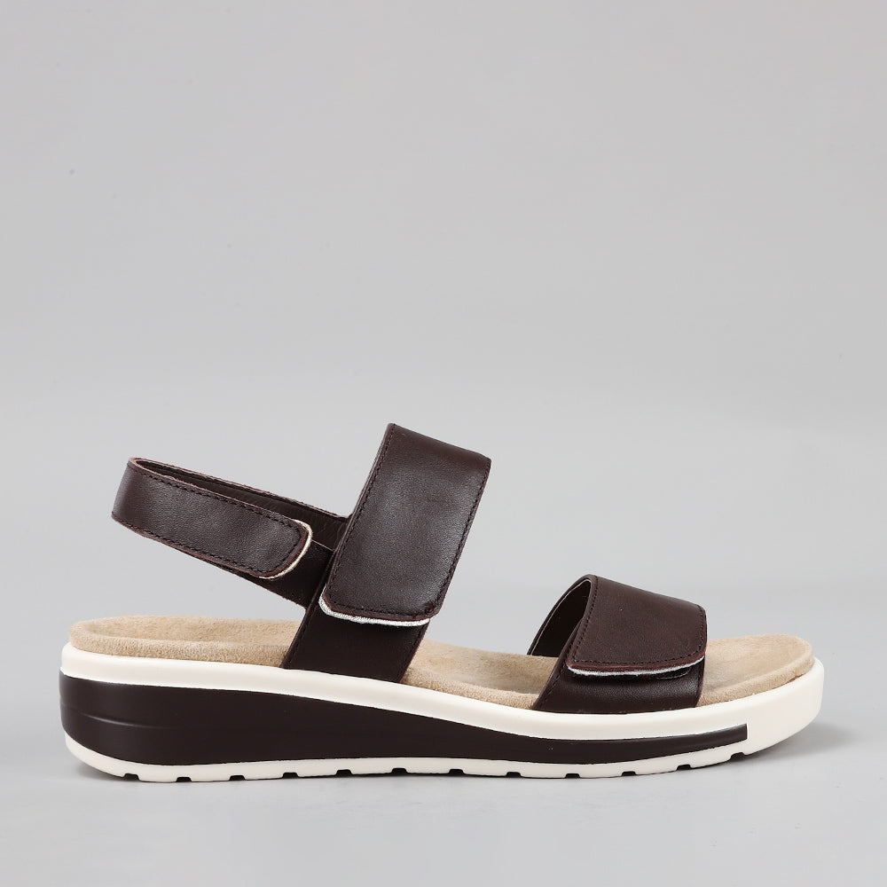 Naked Arches Hanza Chocolate sandals with cushioned straps and contoured footbed, shown from side view on a white background.