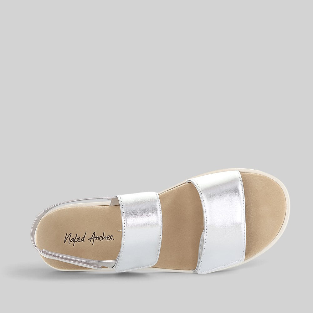 Naked Arches Hanza silver sandals with minimalist straps and metallic finish, showcasing comfortable open-toe footwear style.
