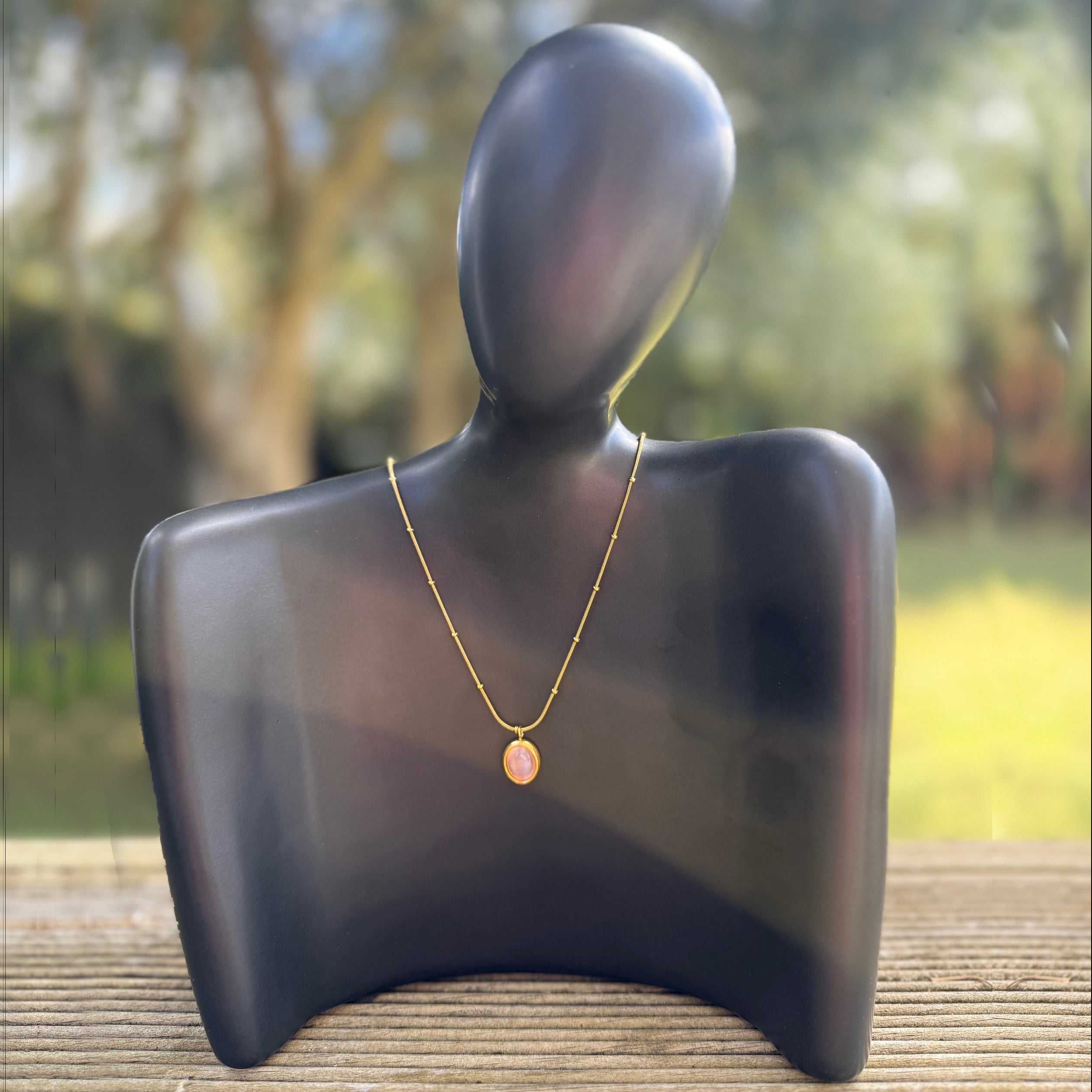 Zeke Collection blush stone pendant necklace featuring a polished blush-colored stone on a delicate chain.