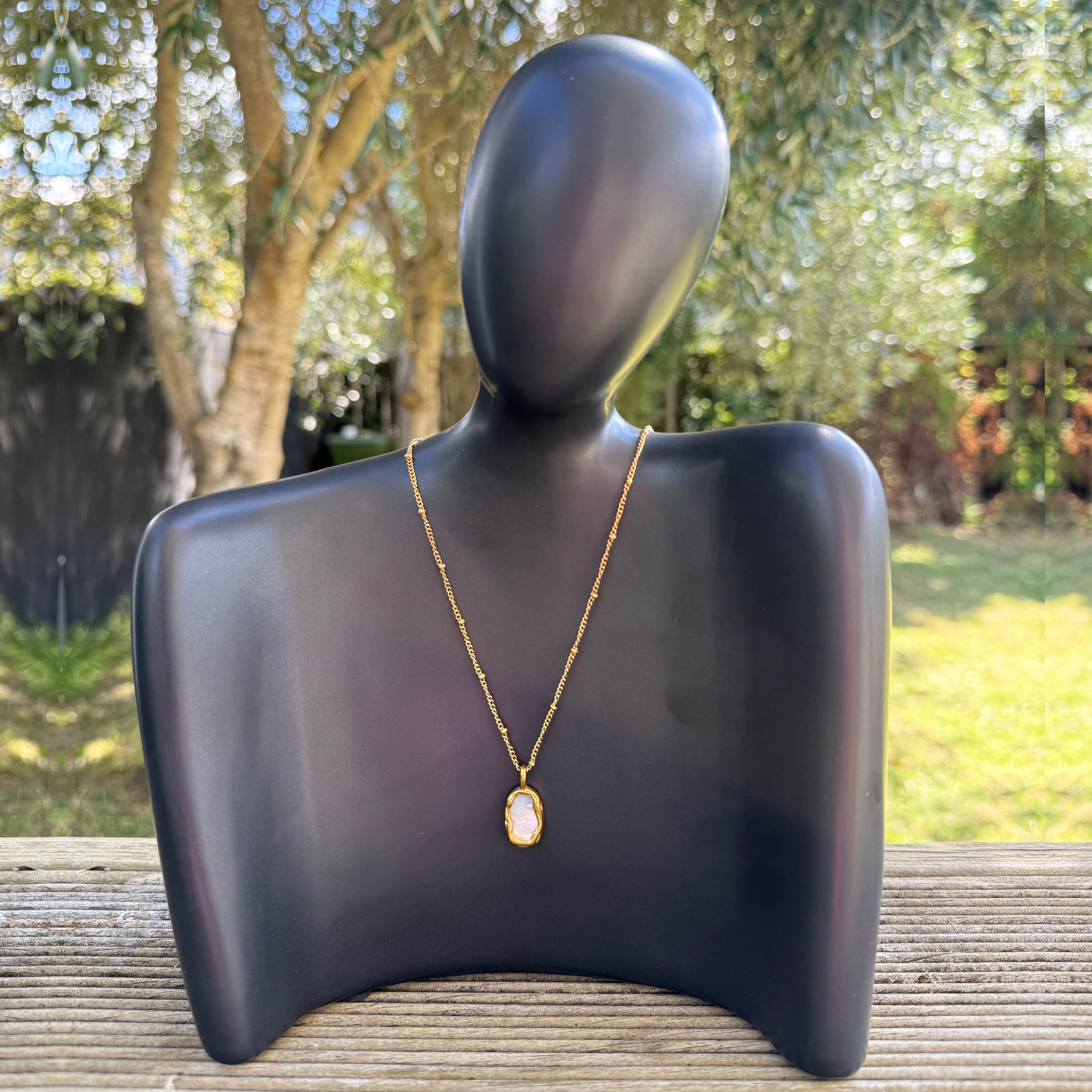 Organic pink stone necklace from Zeke Collection featuring a delicate pendant on a silver chain.