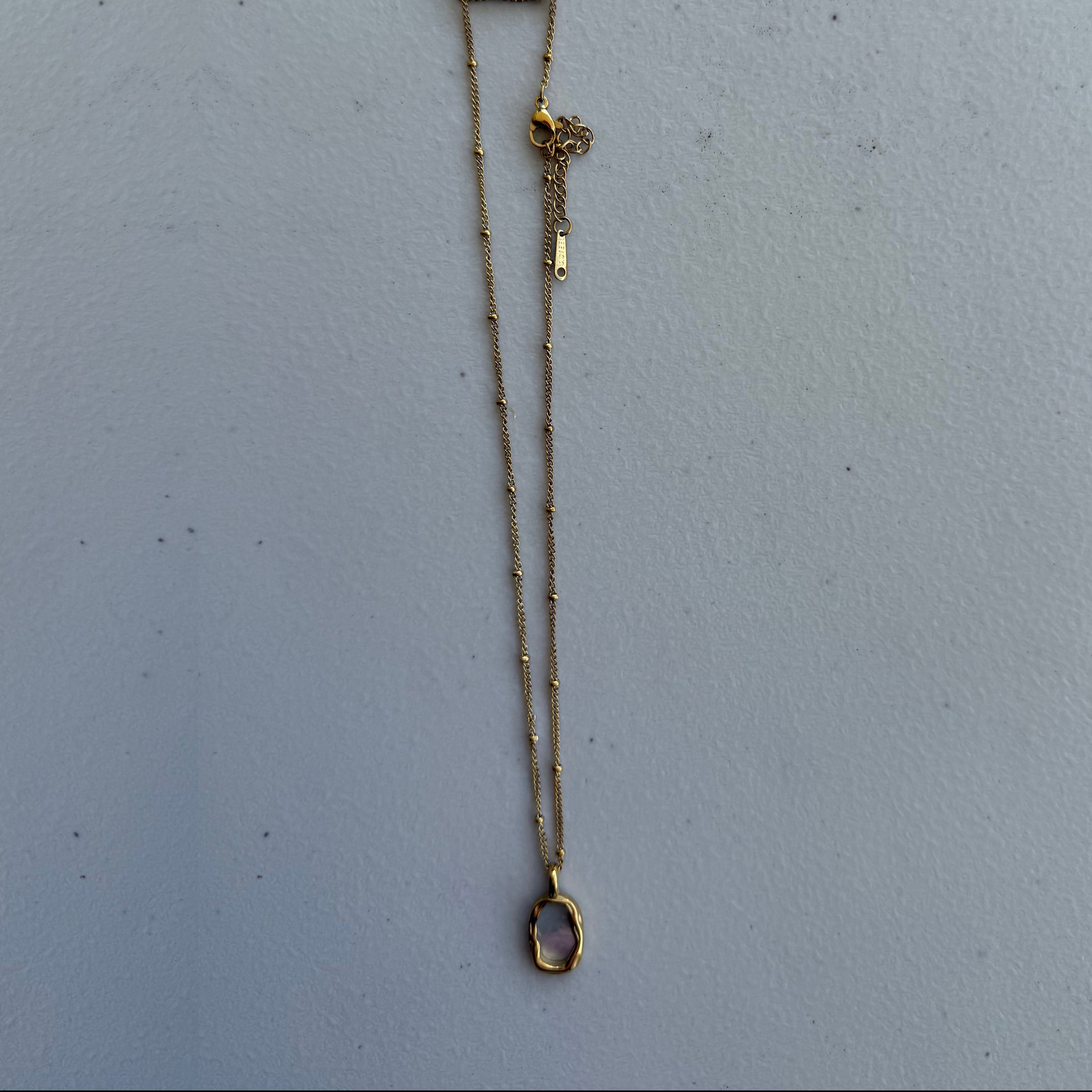 Organic pink stone necklace from Zeke Collection featuring a delicate pendant on a fine chain.