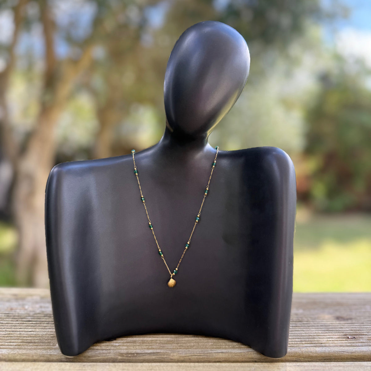 Golden Sun Charm Necklace from Zeke Collection featuring a delicate pendant on a fine chain.