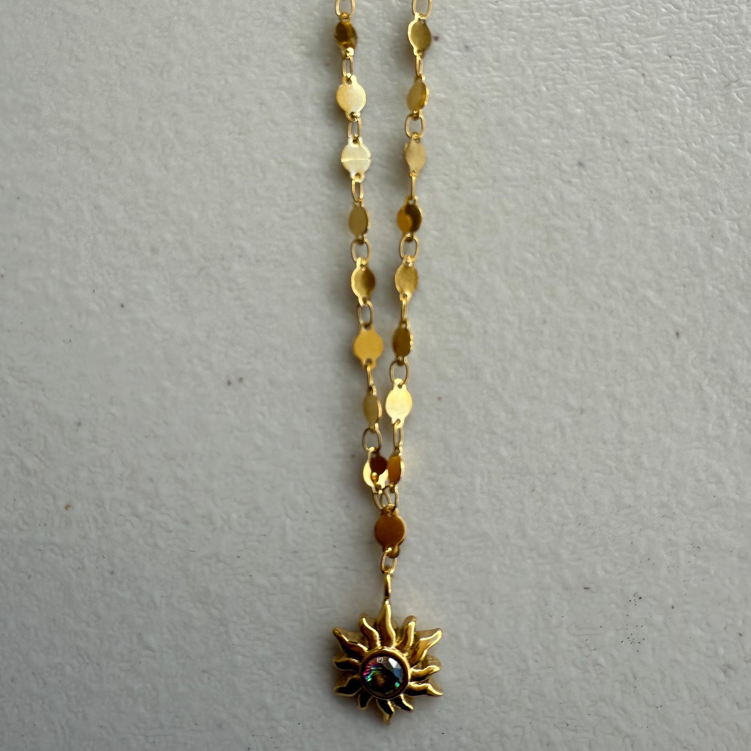 Golden Sun Charm Necklace from Zeke Collection with a delicate pendant, perfect for adding a touch of elegance to any outfit.