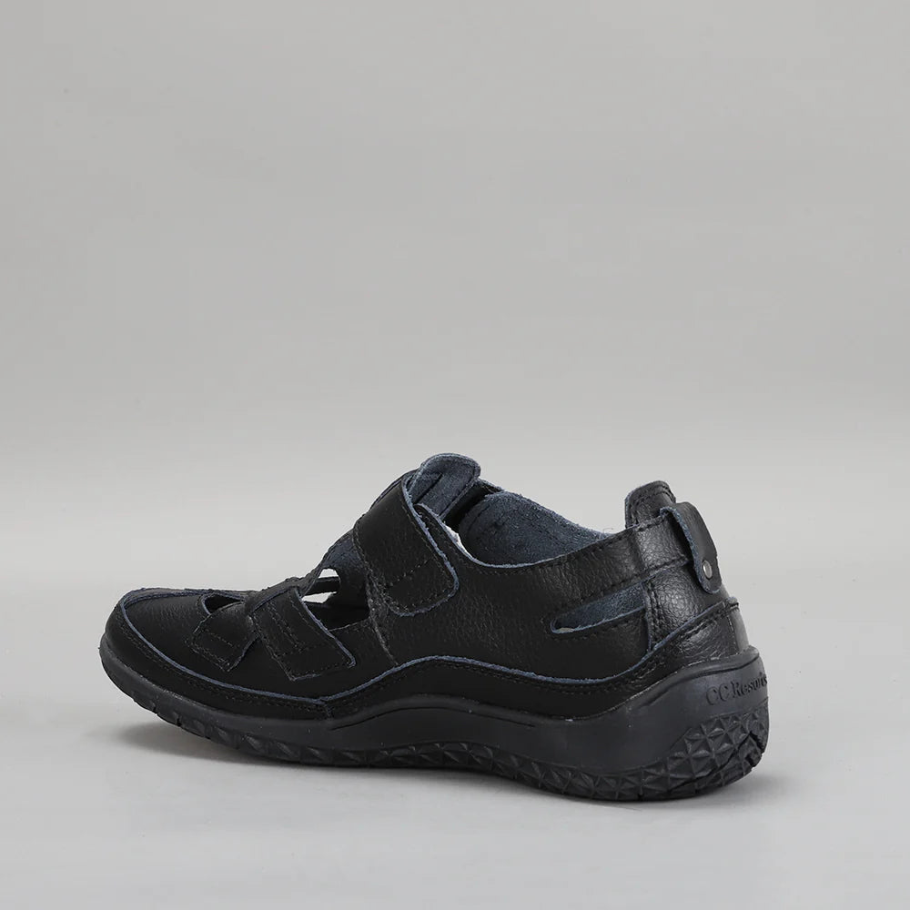 CC Resorts Jackie black flats with pointed toe design, shown on a model, highlighting stylish and comfortable footwear.