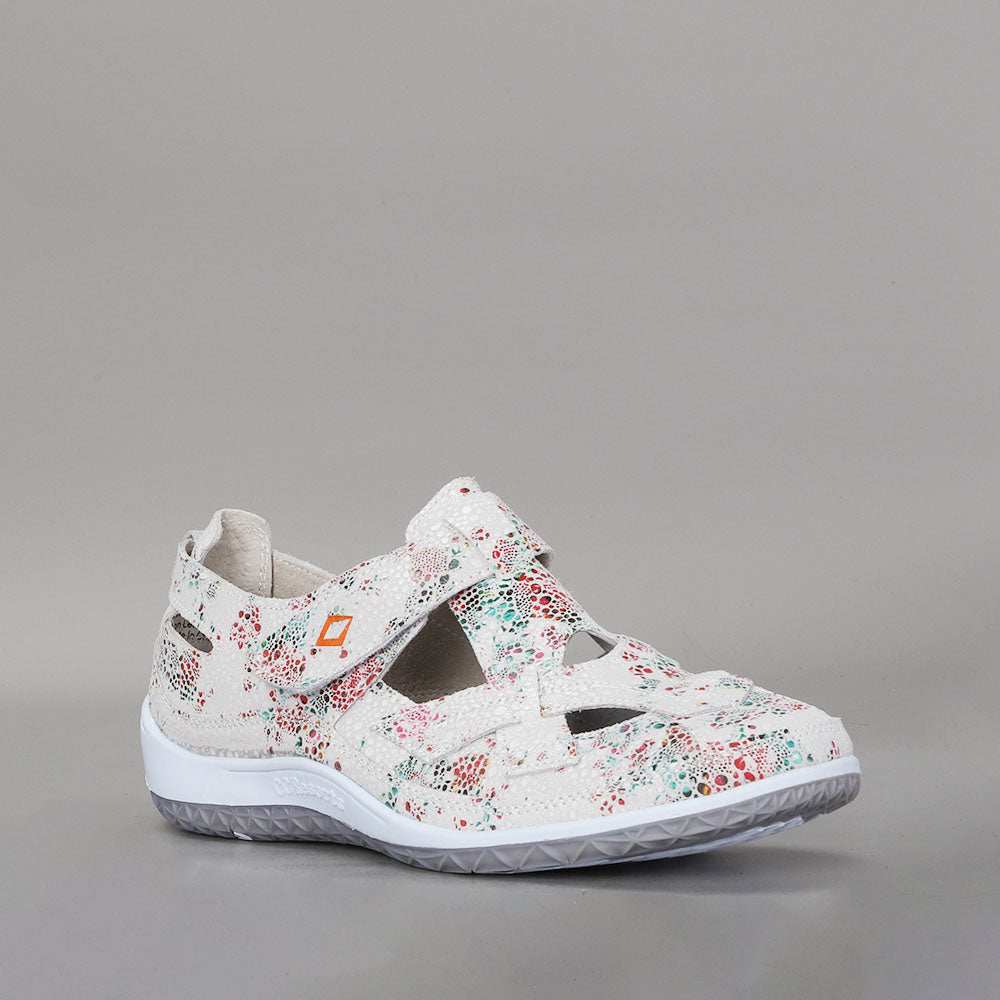 CC Resorts Jackie white and green floral flats shown on a model, showcasing comfortable slip-on footwear for women.