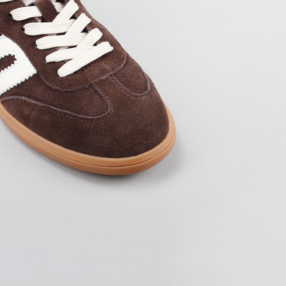 Close-up of Le Sansa Juno sneakers in chocolate suede and ivory color, showing detailed stitching and stylish design.