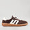 Le Sansa Juno chocolate and ivory sneakers showing side view with suede material and stylish design.