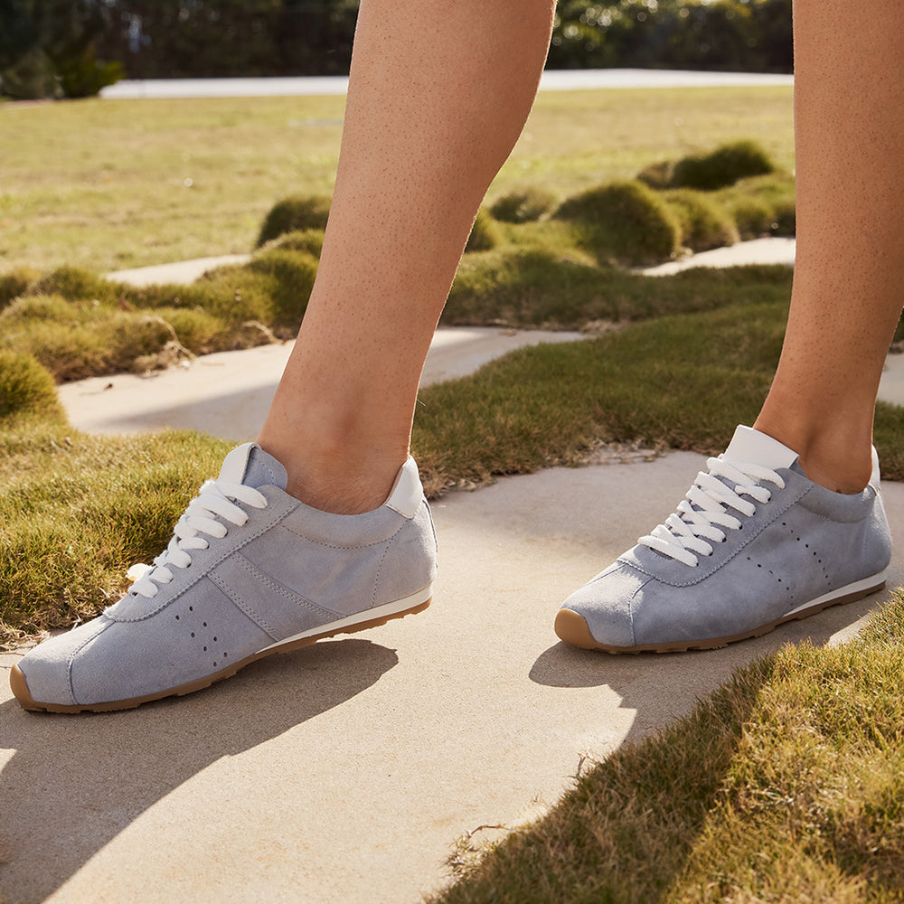 Eos Jas light blue sneakers worn on foot, showcasing stylish casual footwear with a comfortable design.