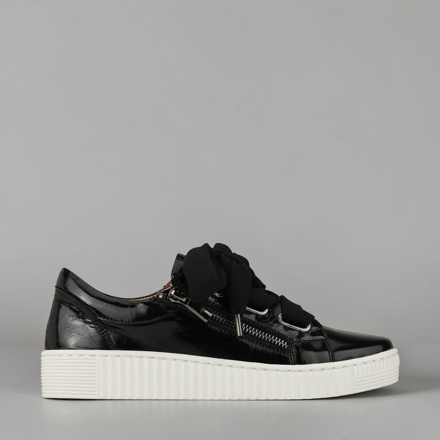 Black patent EOS Jovi sneakers with crinkle finish, showcasing sleek design and stylish comfort.