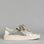 EOS Jovi Champagne sneakers displayed outdoors, featuring a sleek design with champagne-colored accents and stylish laces.
