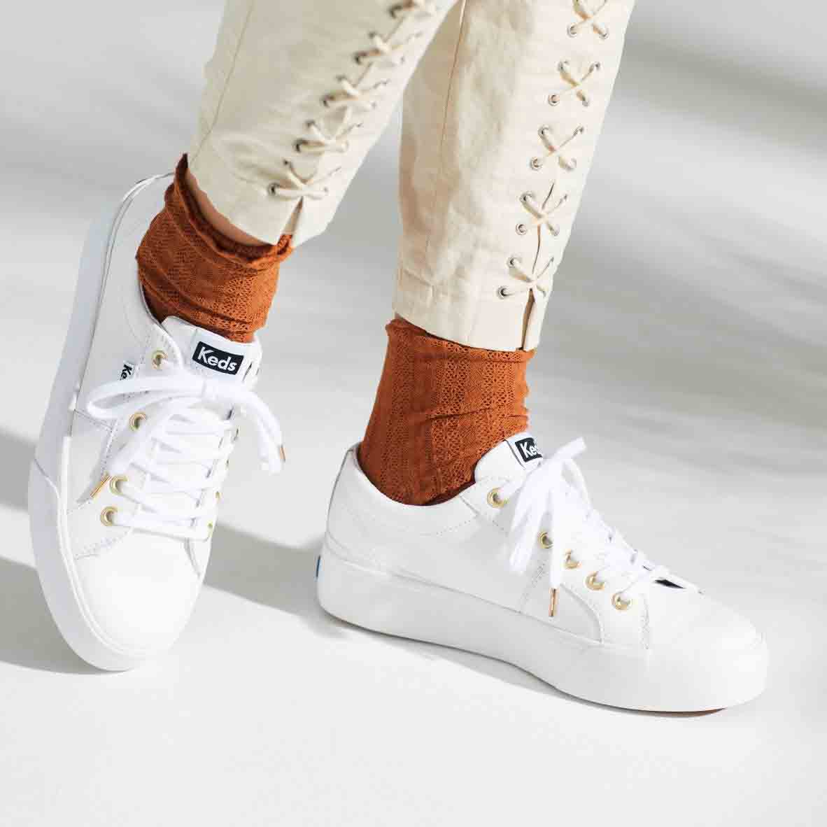 White KEDS Jump Kick Duo sneakers with lace-up design and rubber soles, stylishly displayed on a clean background.