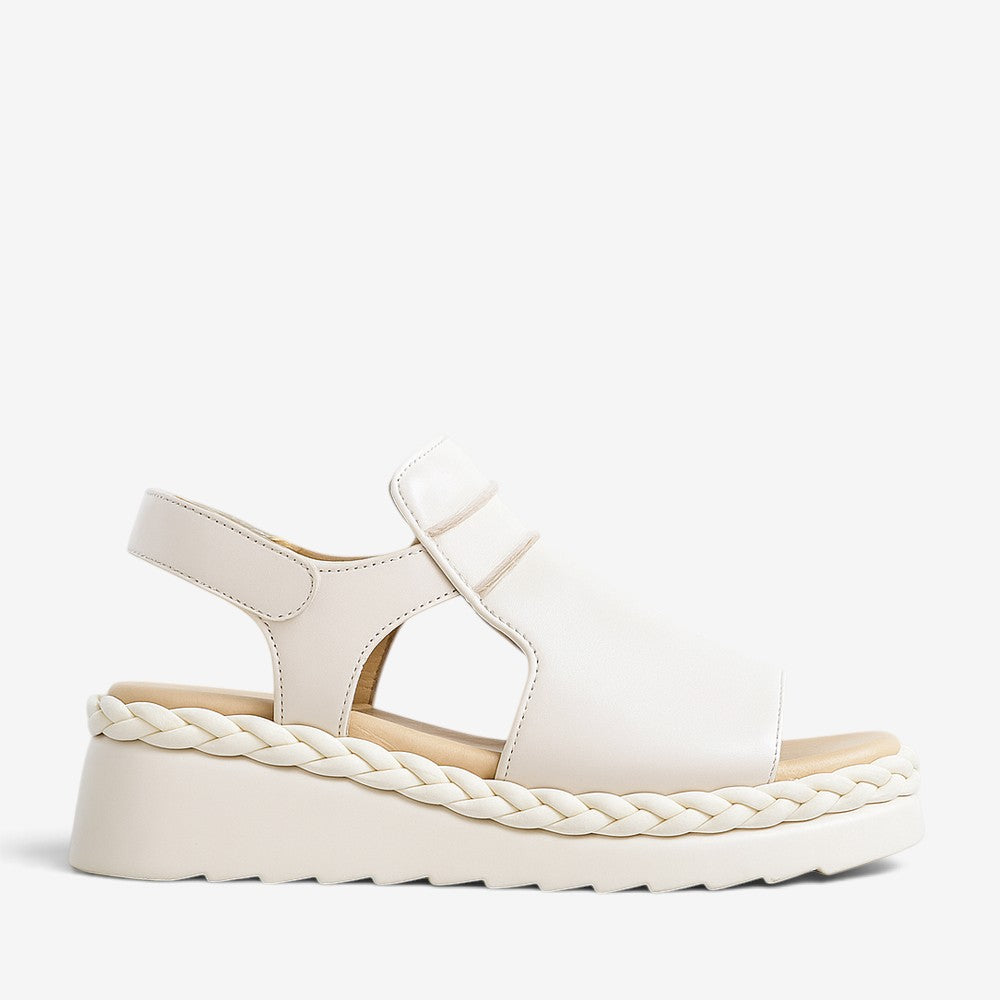 LE SANSA EMMELINE Cream sandals featuring a stylish open-toe design with beige straps and a comfortable flat sole.