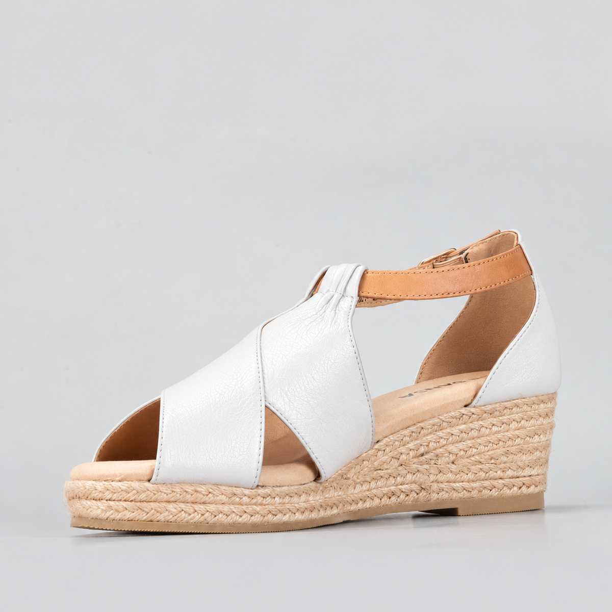 Le Sansa Pernia white and tan sandals with open toes and ankle straps, featuring a stylish, casual design.
