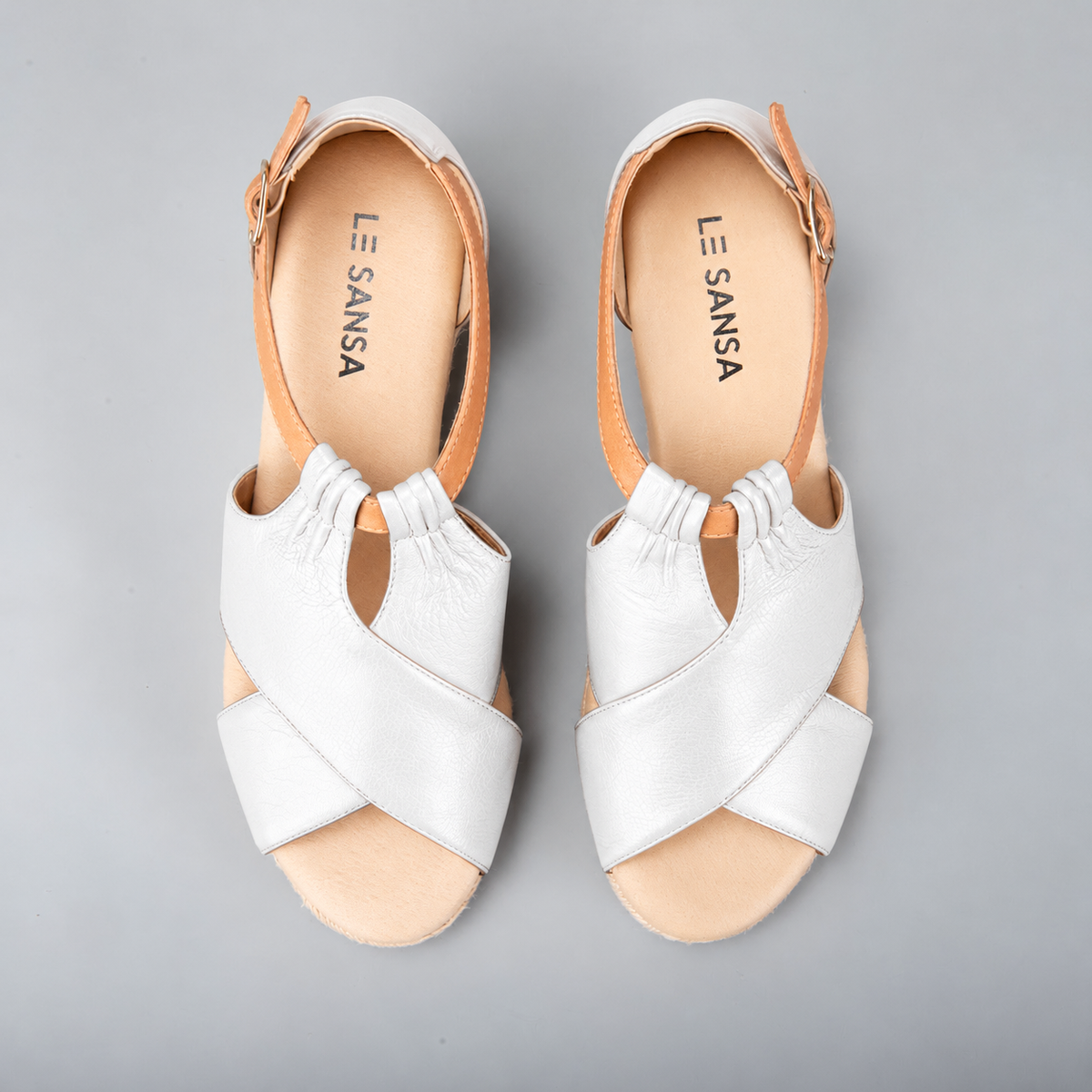 Le Sansa Pernia white and tan sandals with open toe design and ankle straps, stylish footwear for casual summer wear.