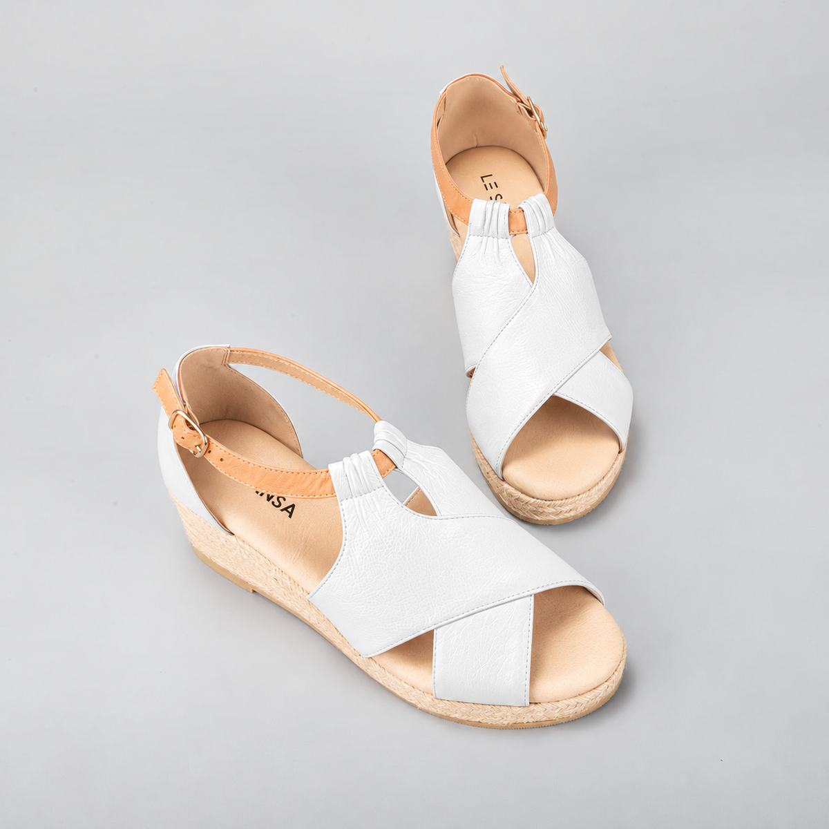 Le Sansa Pernia white and tan sandals with ankle straps and open toes, stylish footwear for casual or summer wear.