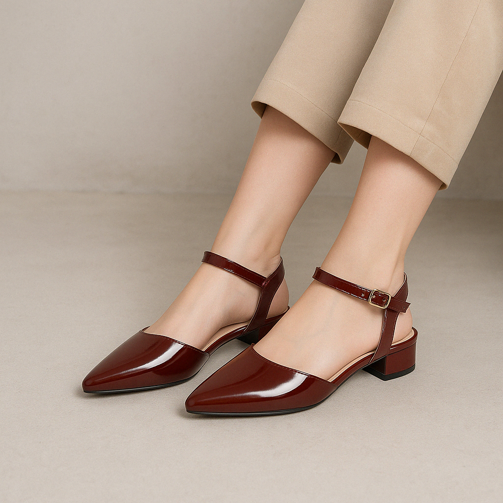 Le Sansa Coralie Merlot Patent sandals featuring glossy red patent leather straps and a stylish open-toe design.