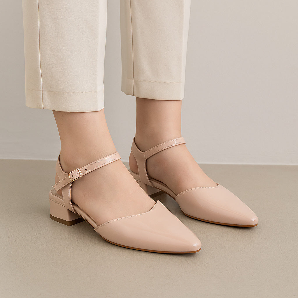 Le Sansa Coralie Nude Patent sandals with sleek straps and a glossy finish, perfect for stylish summer footwear.