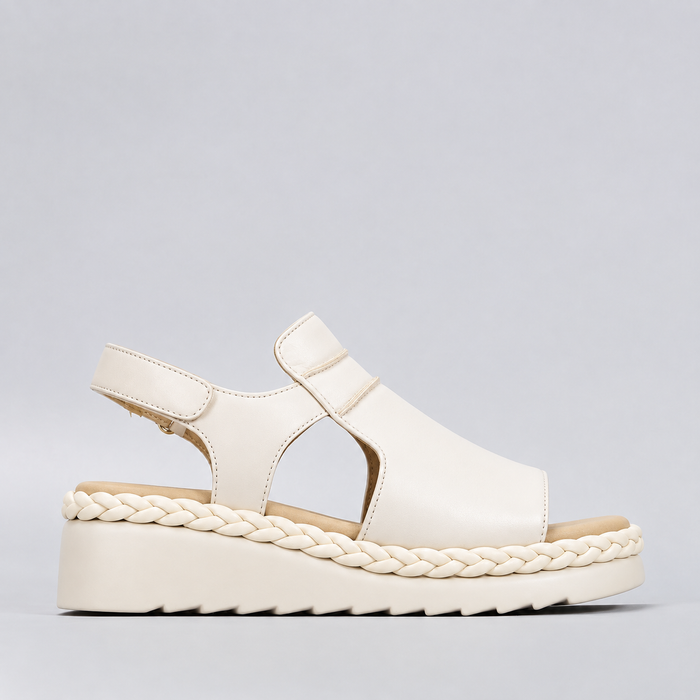 Le Sansa Emmeline cream-colored sandals with strap detailing and low heel, stylish footwear for casual or dressy occasions.