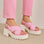 Pink LE SANSA France sandals with open-toe design and ankle straps, stylish footwear for warm-weather outfits.