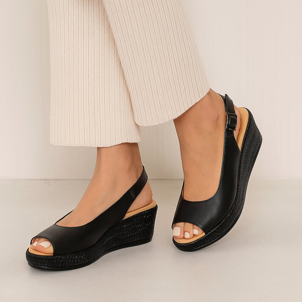 Black Le Sansa Petunia sandals with open toe design and ankle straps, showcasing stylish and comfortable footwear.