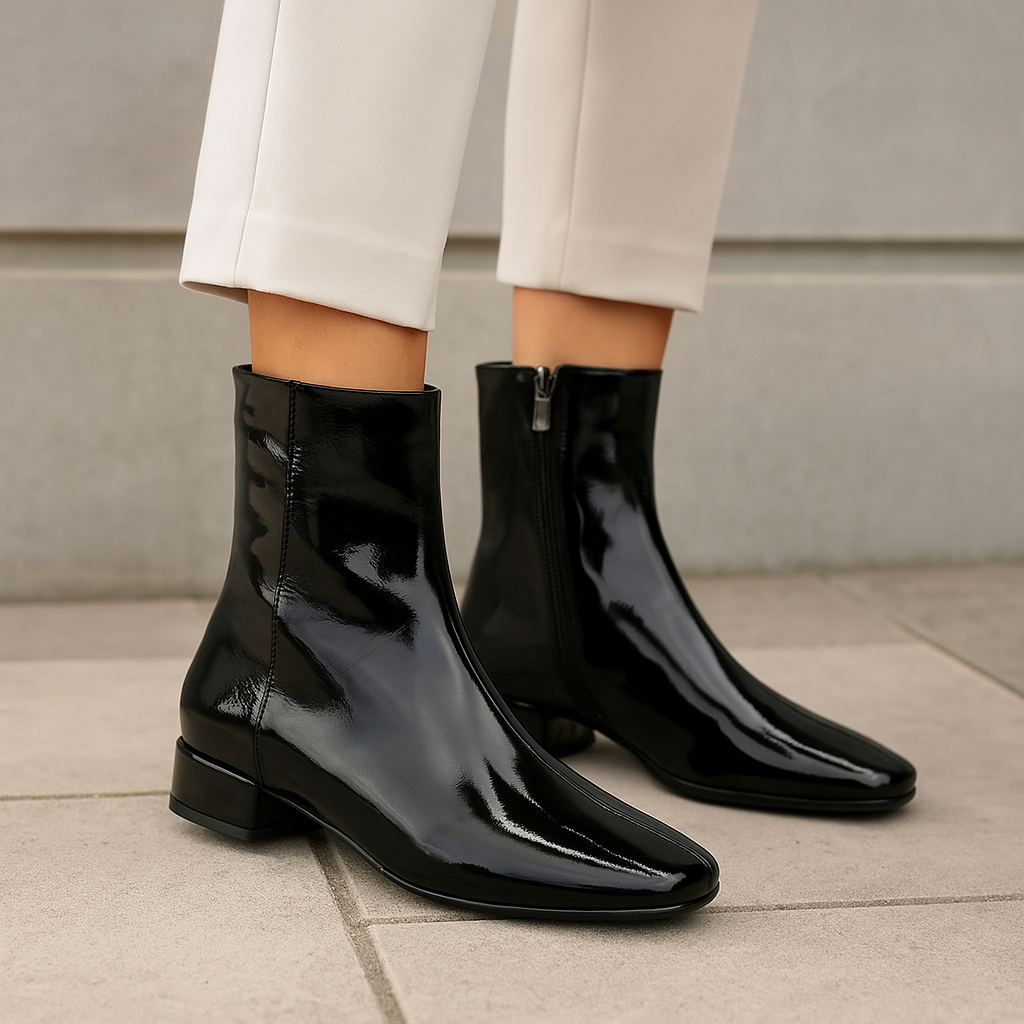 Black patent leather boots by Le Sansa Sasha featuring sleek design and pointed toes.