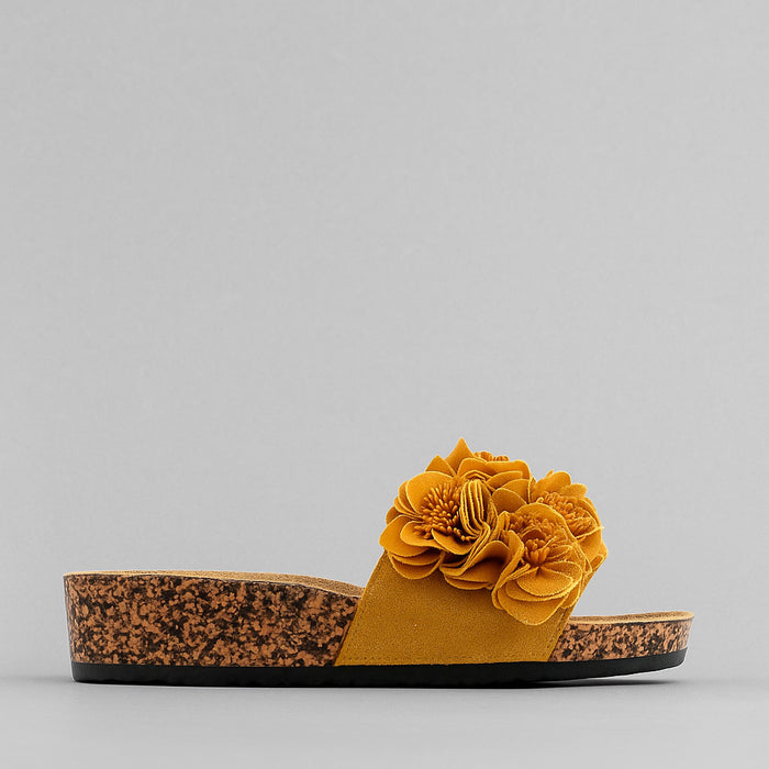 Los Cabos Corsage Amber slippers featuring a soft, cushioned design with floral accents and warm amber tones.