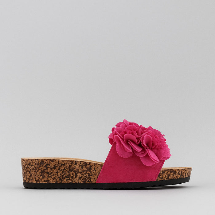 Pink slippers with floral corsage design by Los Cabos, featuring comfortable slip-on style and vibrant fuchsia color.