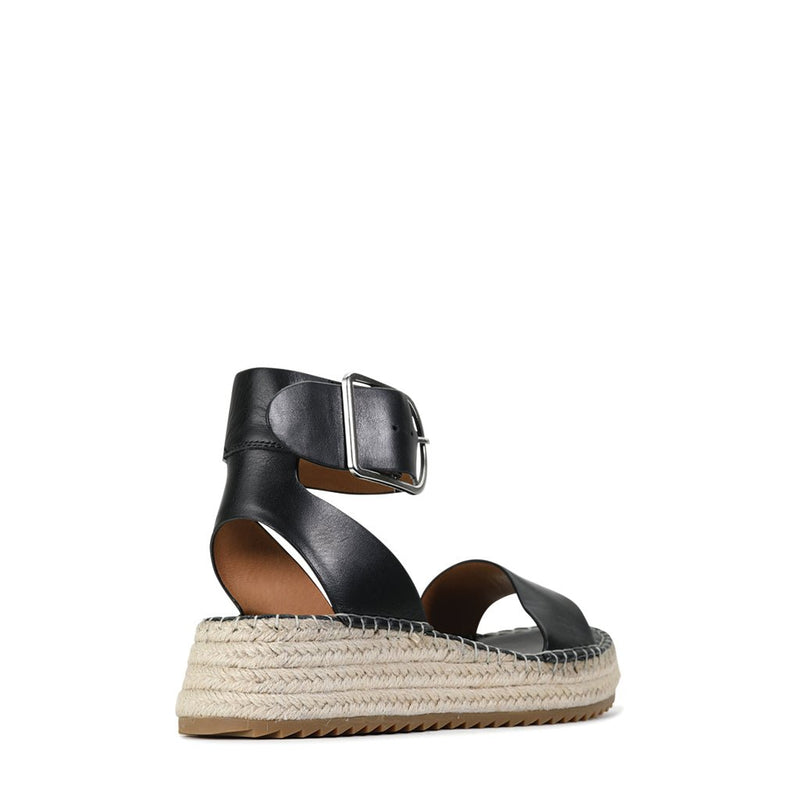 Eos Larah black sandals displayed from the back angle, featuring sleek straps and a comfortable flat sole.