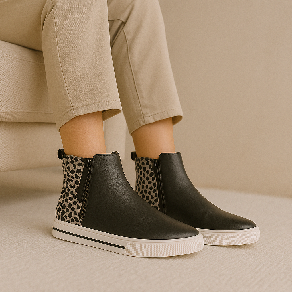 Le Sansa Indo black leopard boots featuring a stylish black and leopard print design with ankle-high silhouette and pointed toe.
