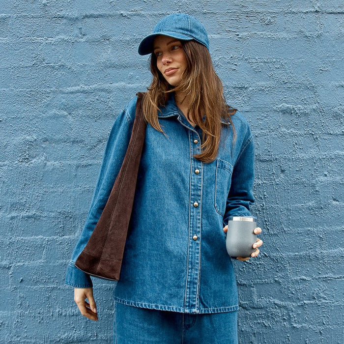 Betty Basics Vespa denim shirt, casual long-sleeve top with button front and collar, displayed on a hanger.