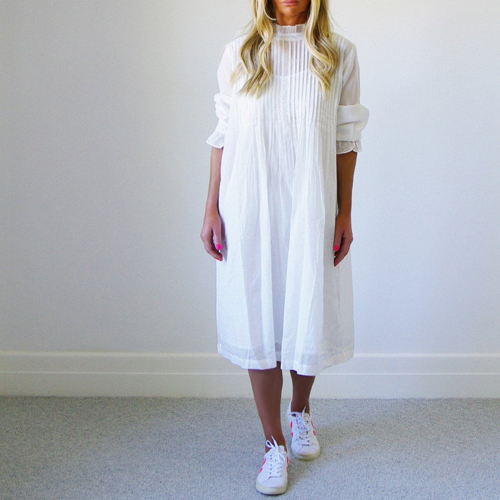 Who's Charlie Morgan French Vanilla dress featuring a stylish jumpsuit design, displayed on a hanger with detailed fabric texture.