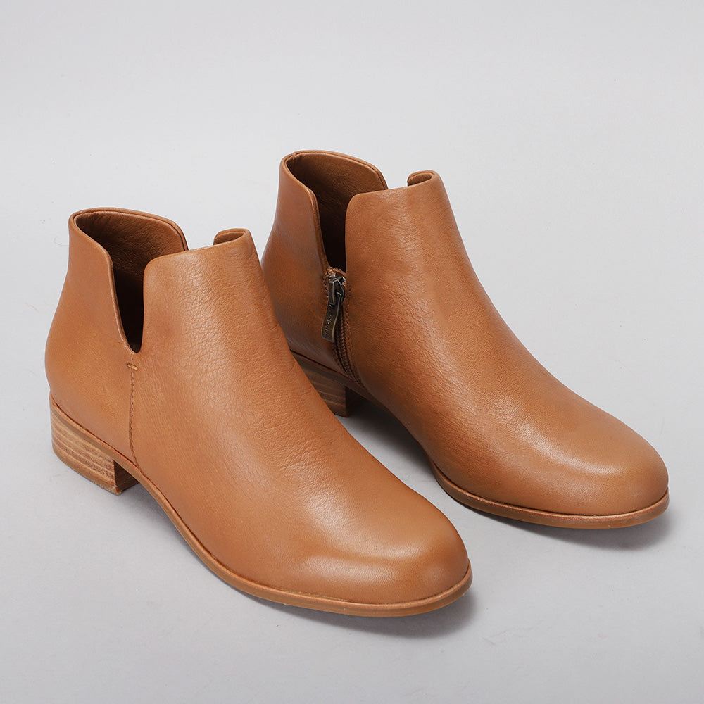 Pair of LE SANSA MARA TAN boots showcasing sleek, tan leather footwear with stylish laces and a sturdy sole.