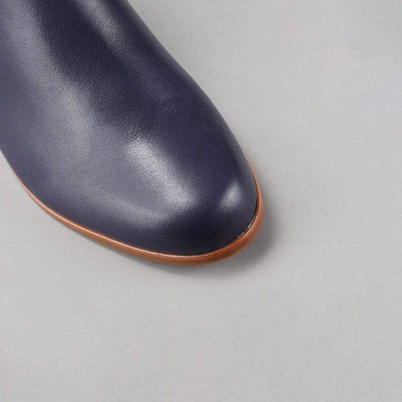 Close-up of Le Sansa Murphy Navy boots showing navy leather material and detailed stitching.