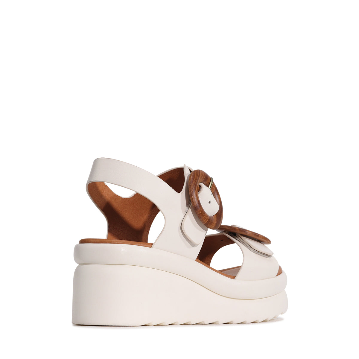 Eos Menorcas bone-colored sandals featuring open toe design, ankle straps, and casual style for comfortable summer wear.