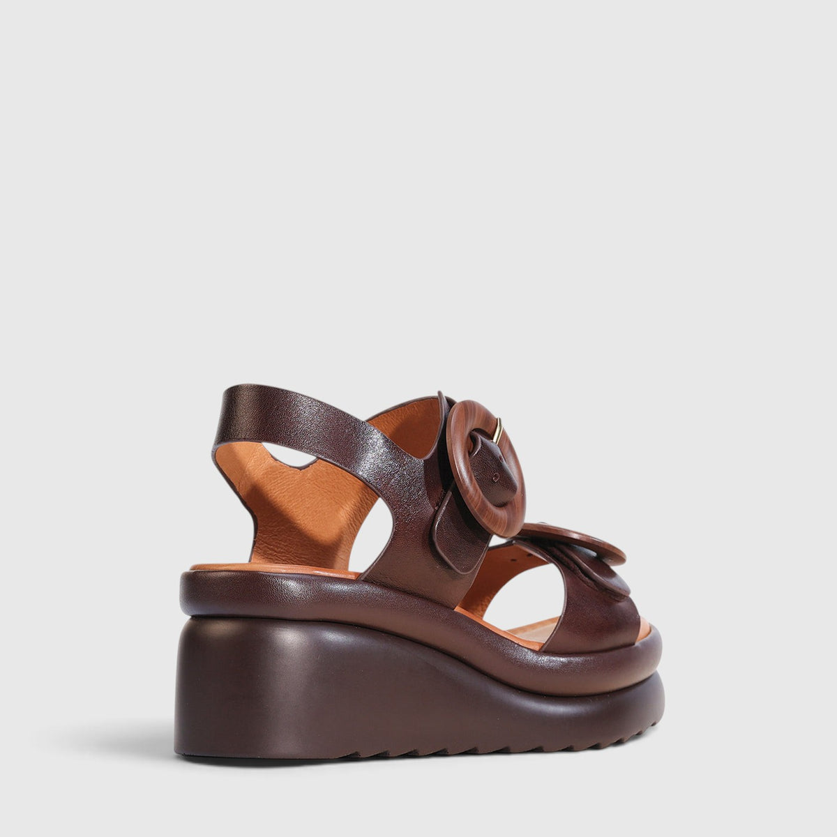 Eos Menorcas chestnut sandals with open toe design, featuring tan leather straps and cushioned sole for casual summer wear.