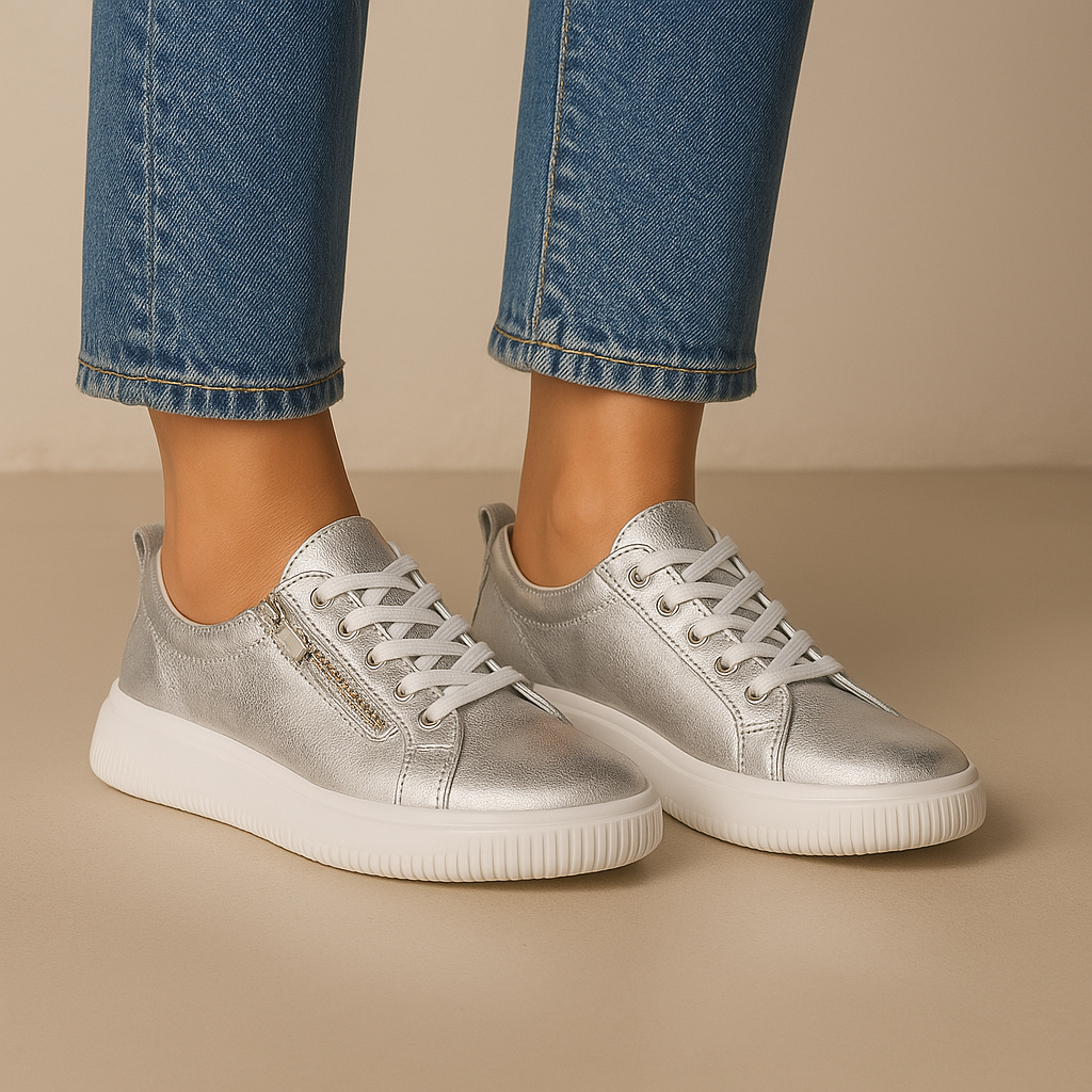 Naked Arches Nelly Silver sneakers with sleek silver design and comfortable casual fit, displayed on a plain background.
