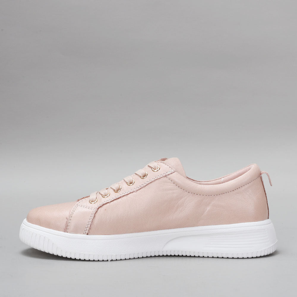Naked Arches Nelly Blush sneakers featuring a soft pink color with white soles and stylish design details.