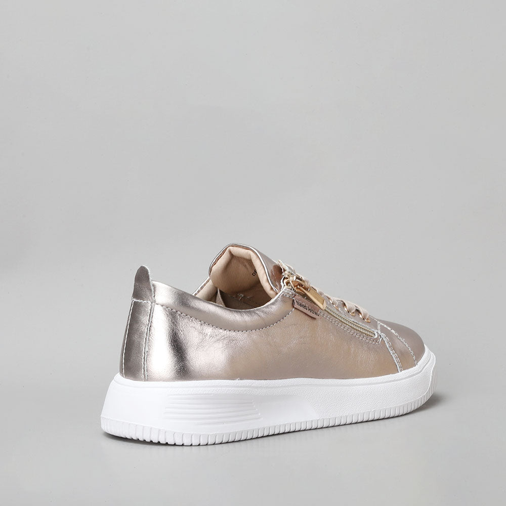 Naked Arches Nelly Champagne sneakers with beige and champagne-tone design, casual slip-on style, and comfortable fit.