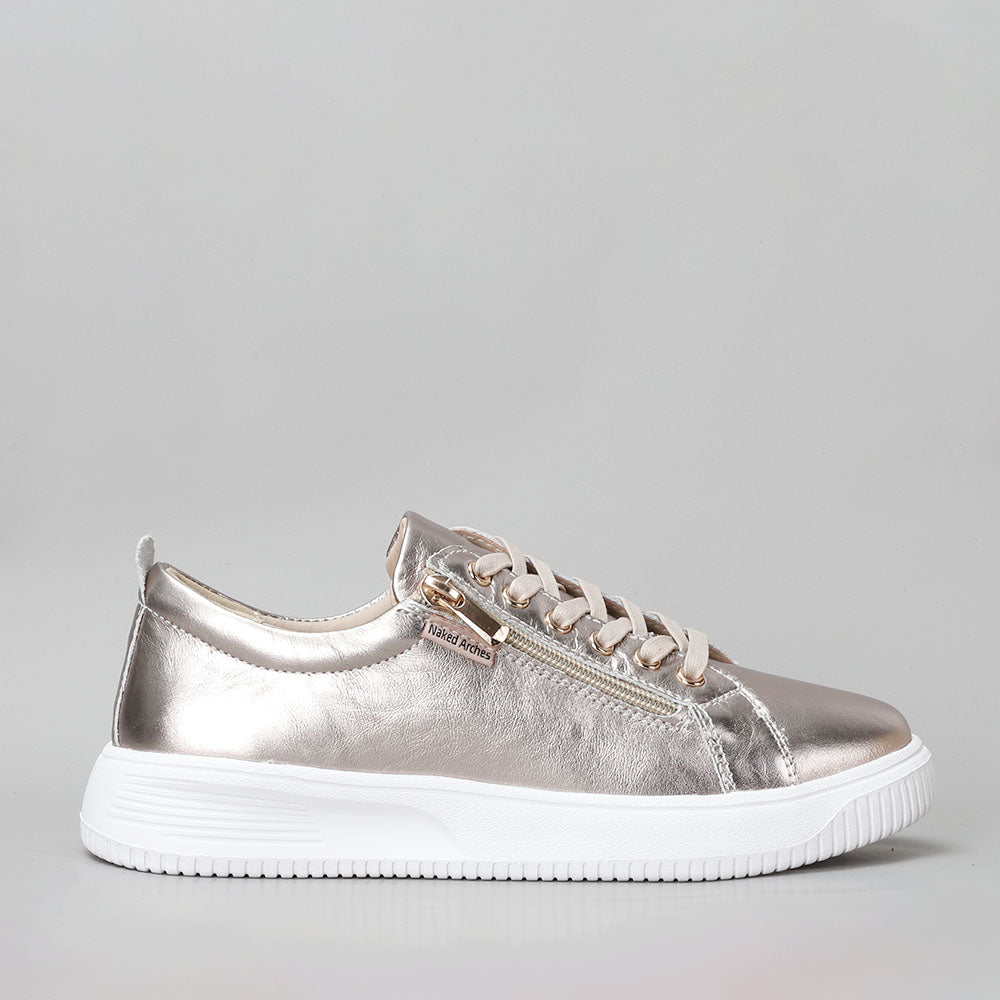 Naked Arches Nelly Champagne sneakers with beige and champagne-colored design, showcasing casual slip-on style and comfortable fit.