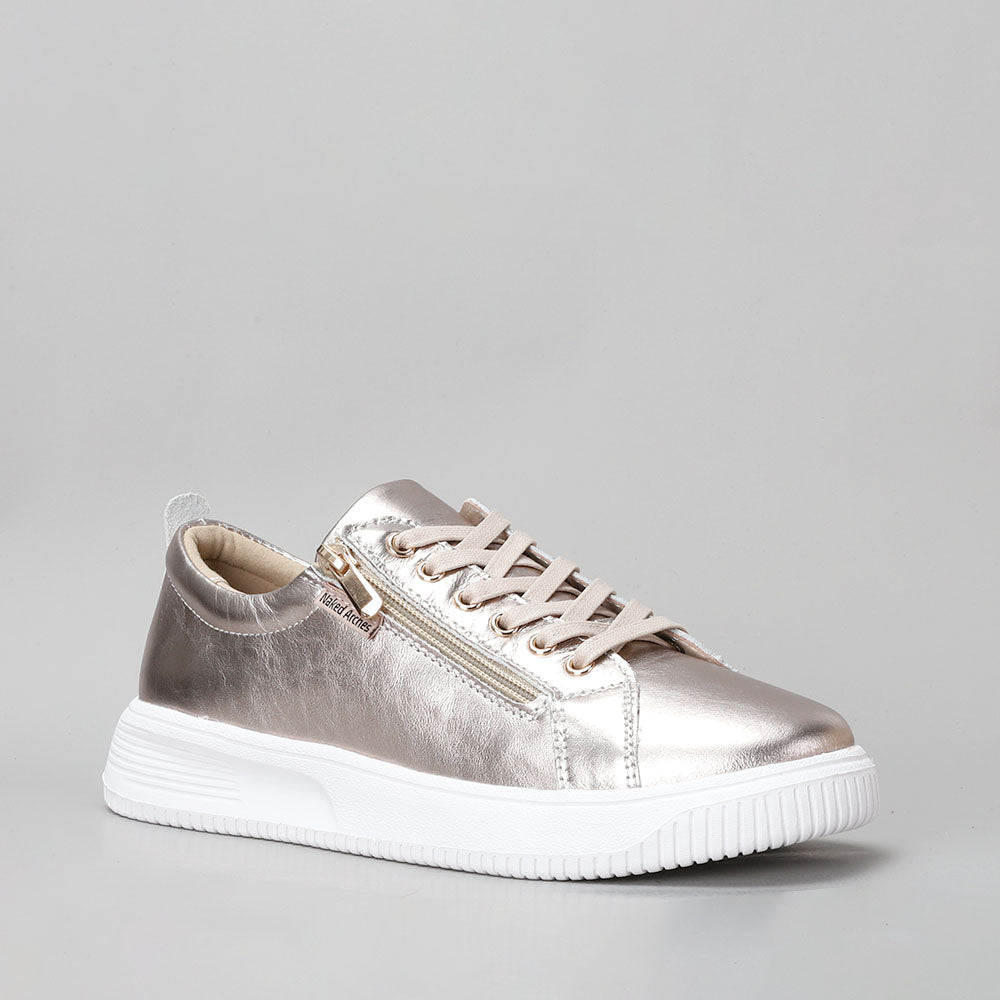 Naked Arches Nelly Champagne sneakers featuring a beige and champagne-colored design with a casual lace-up style and comfortable silhouette.