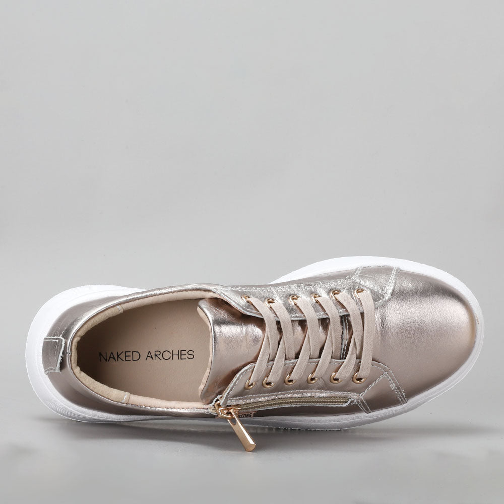 Naked Arches Nelly Champagne sneakers with beige and white design, featuring stylish laces and a comfortable casual fit.